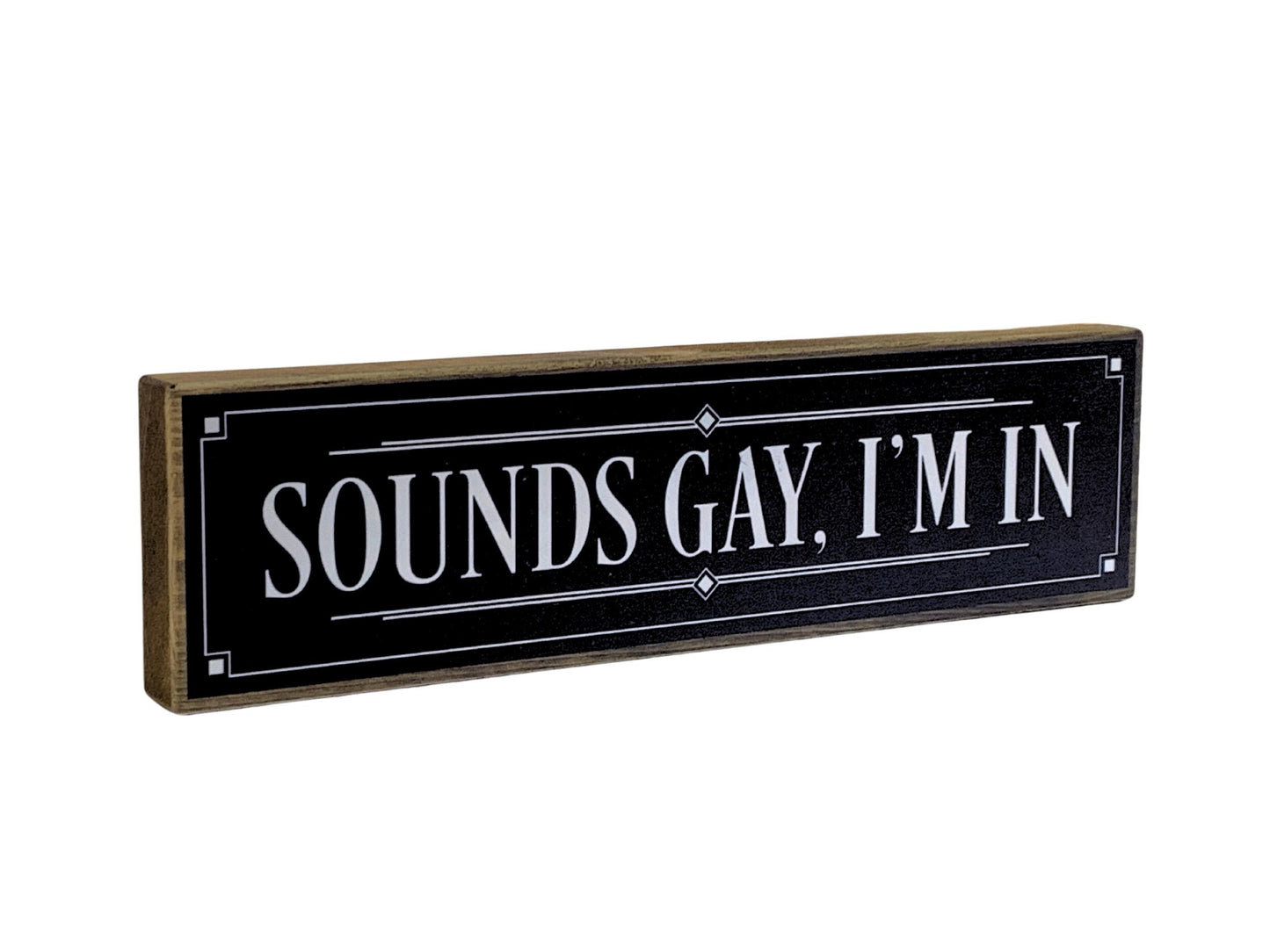 Black sign with white text 'SOUNDS GAY, I'M IN' on a white background