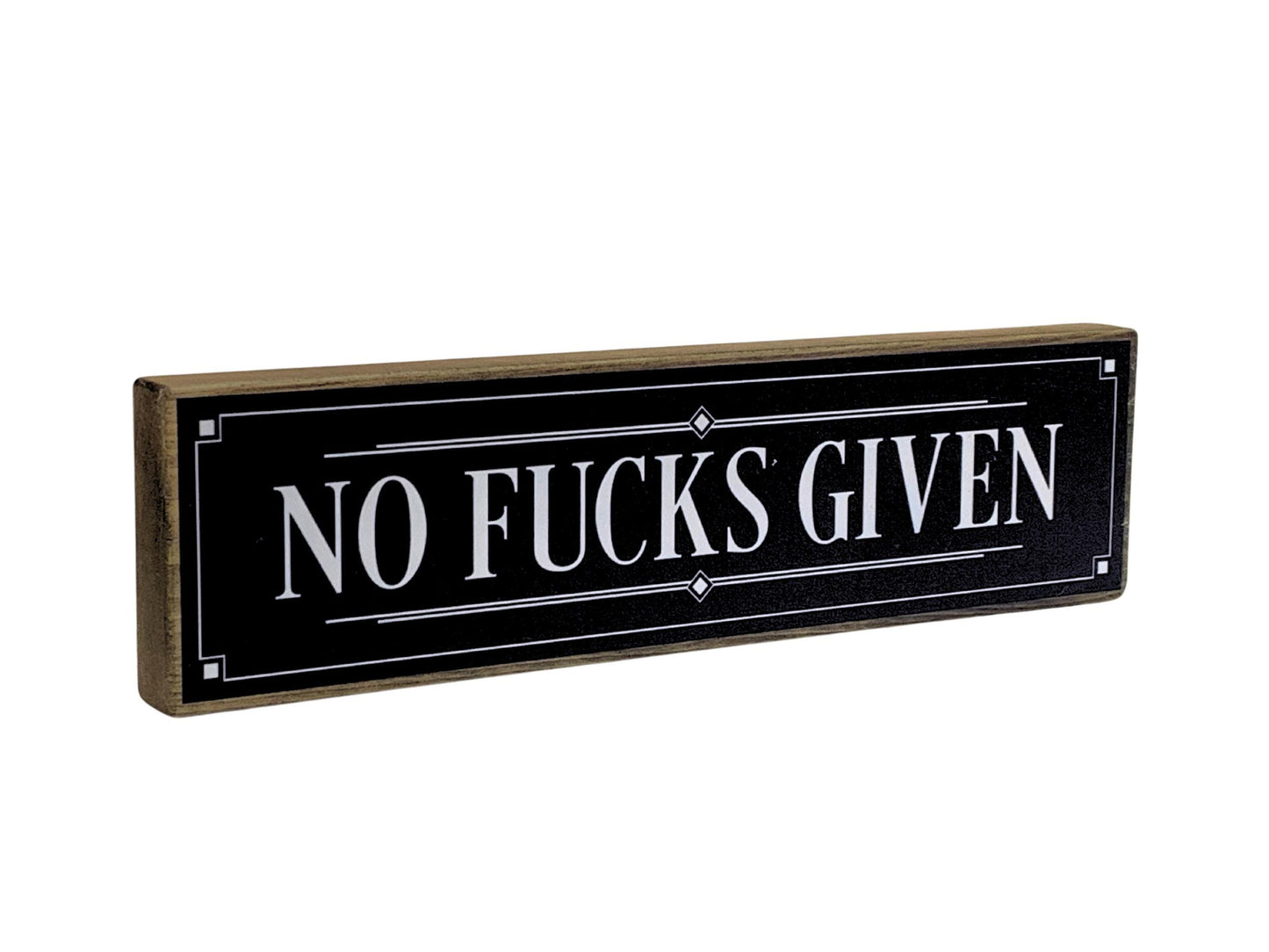 Decorative sign with 'NO FUCKS GIVEN' text on a black background