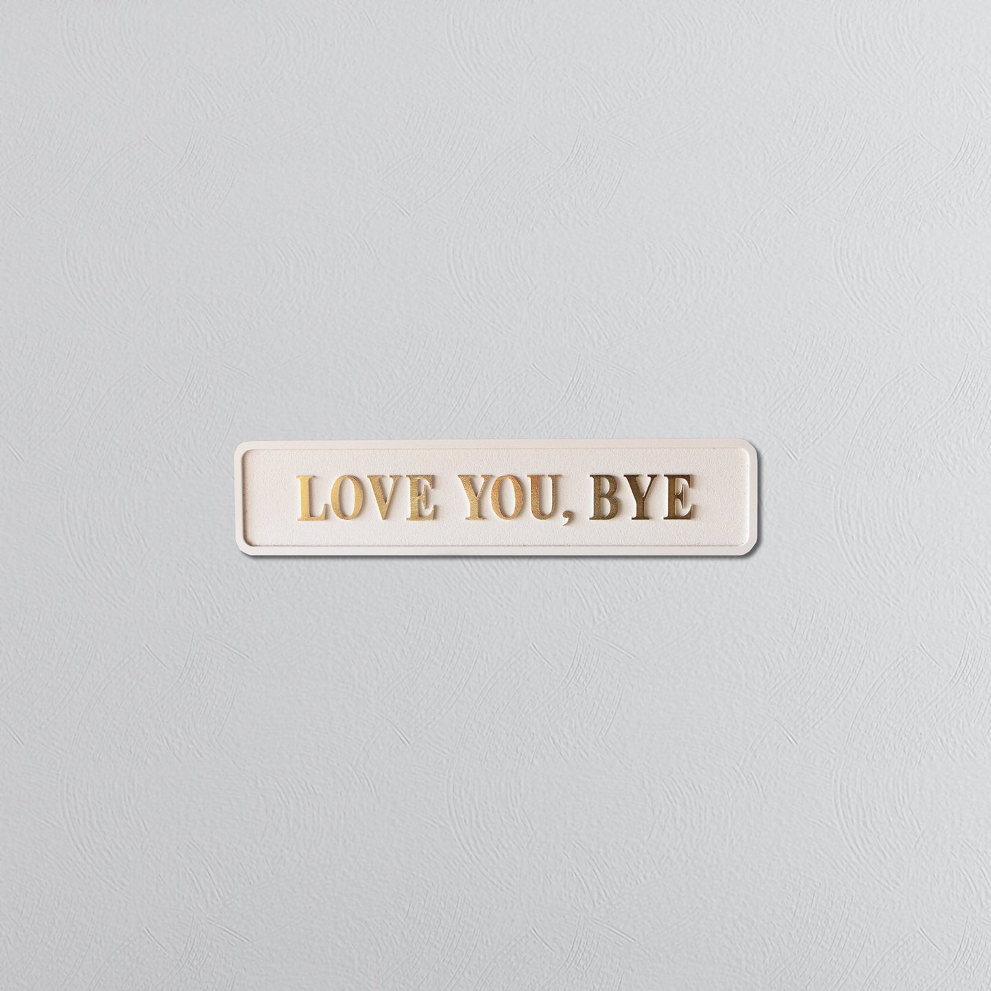 Cream and gold foiled street sign with "love you, bye" lettering