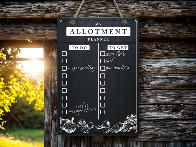 Large chalkboard hanging from black rope with weekly meal plan writen on it