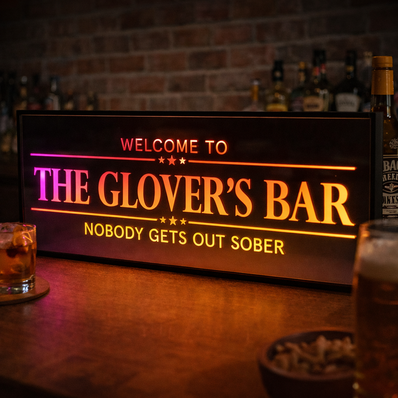 NEON PERSONALISED BAR SIGN GLOWING ORANGE IN A HOME BAR