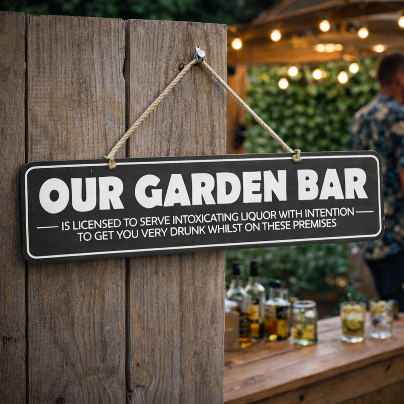 FUNNY GARDEN BAR SIGN HANGING IN A GARDEN