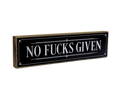 Decorative sign with 'NO FUCKS GIVEN' text on a black background