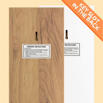 back of the growth charts, one natural wood and the other white, with key slot and hanging instructions on a beige background