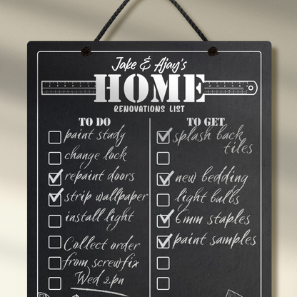Personalised chalkboard hung with black rope and 'Home Renovations List' at the top and 'to do' & 'to get' collumns with check boxes