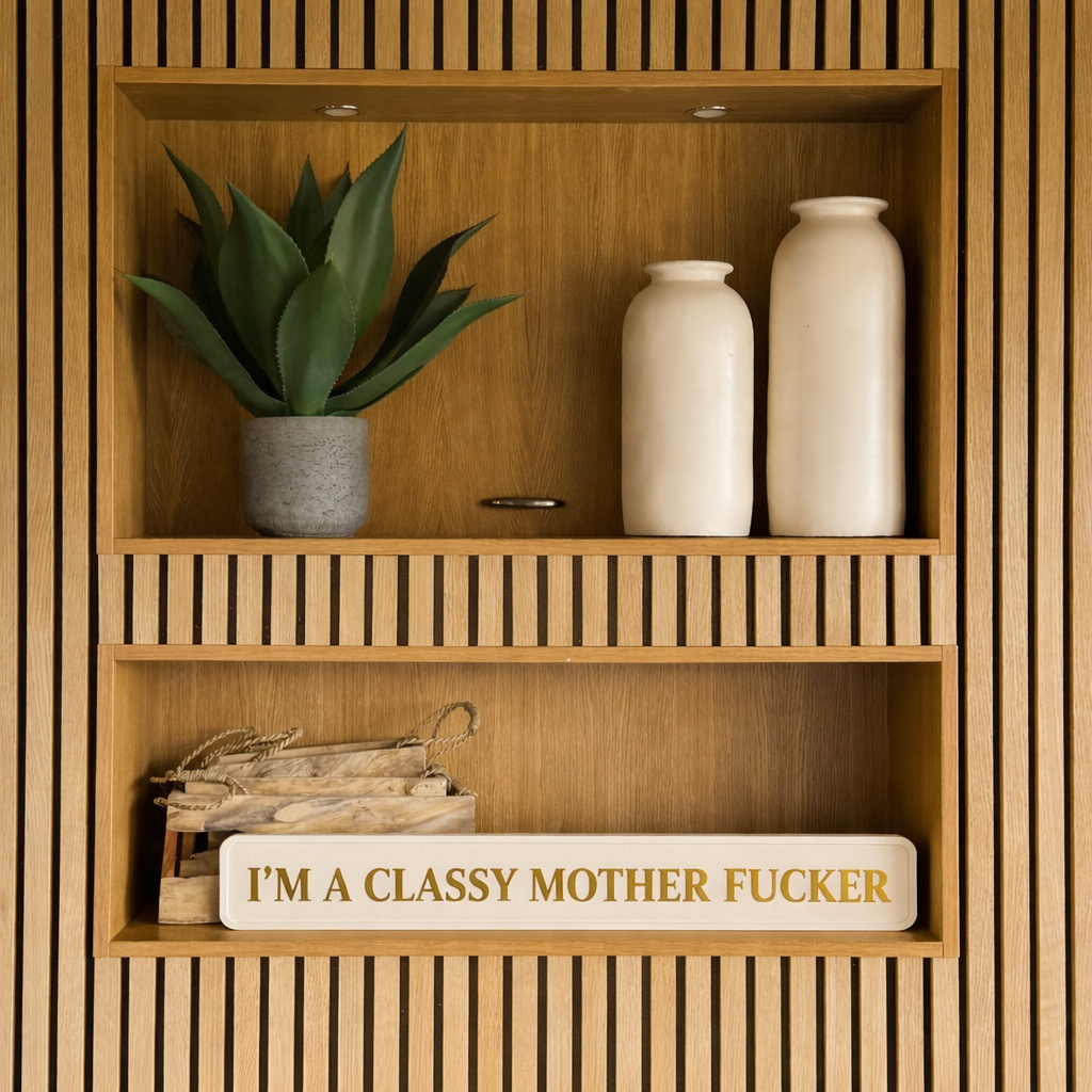 Wooden shelf with decorative items including a plant, vases, and a humorous sign reading I'M A CLASSY MOTHER FUCKER.