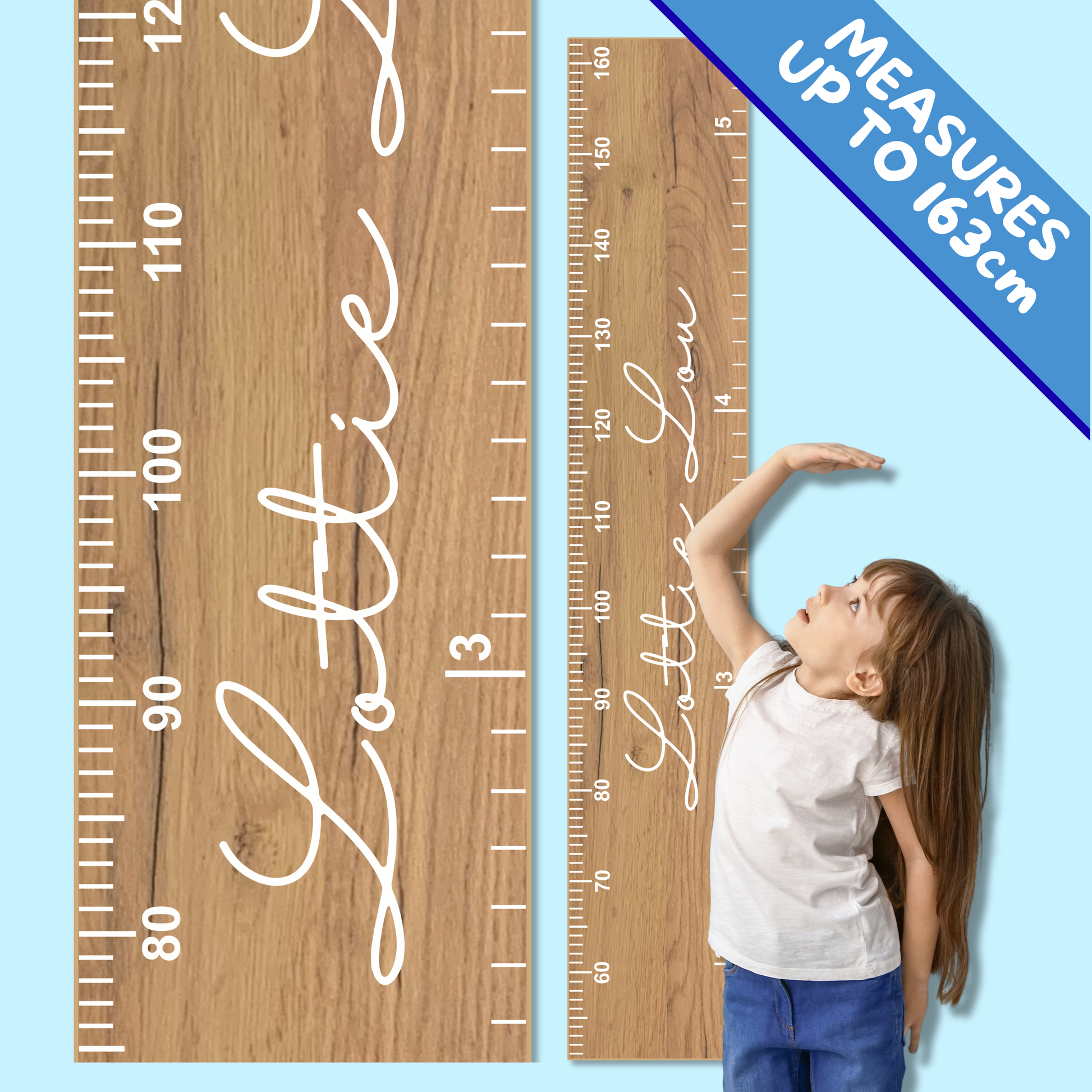 Wooden growth chart personalised with a name in script font, with child measuring herself against it
