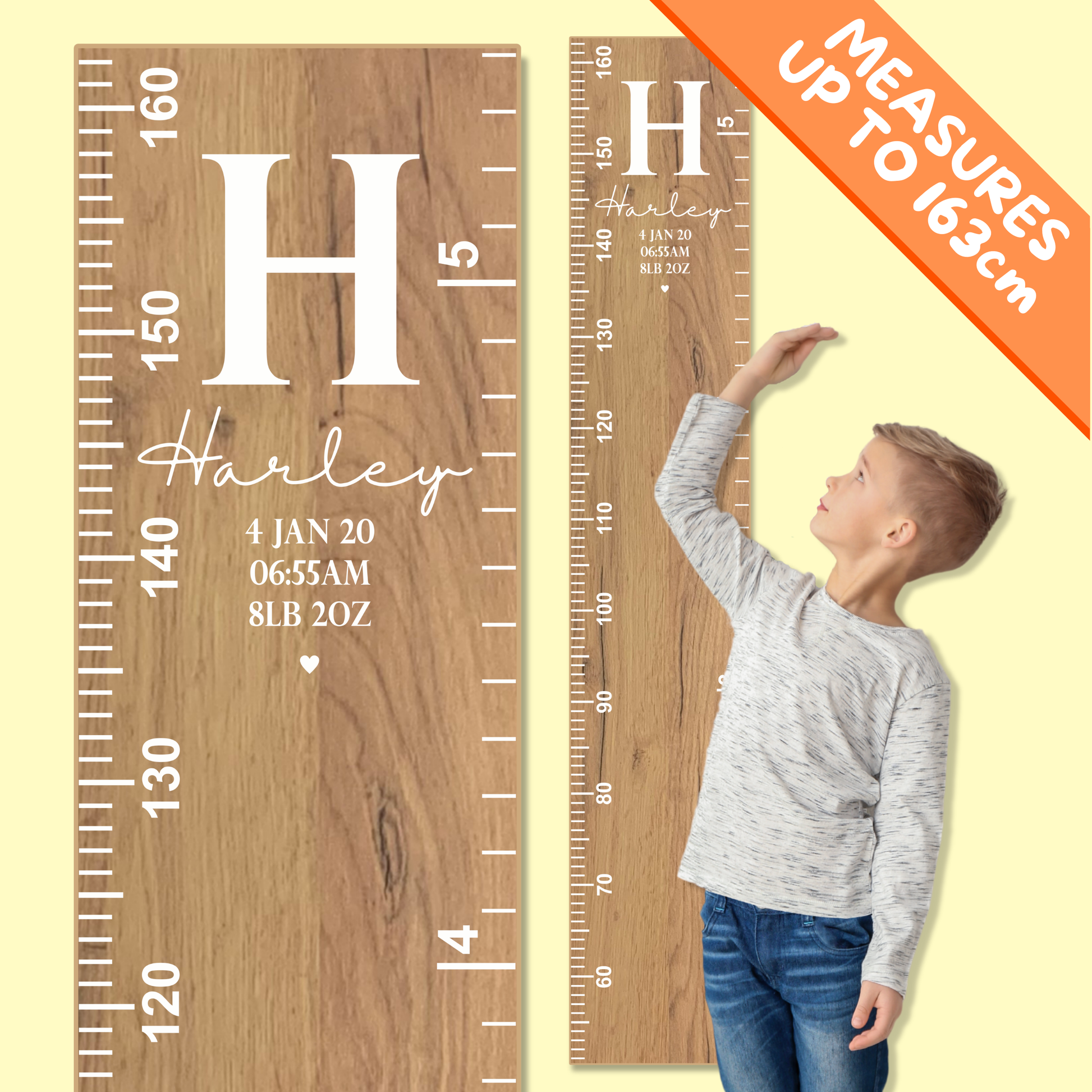 Wooden growth chart with personalised name, monogram and birth information, and a child reaching up to it