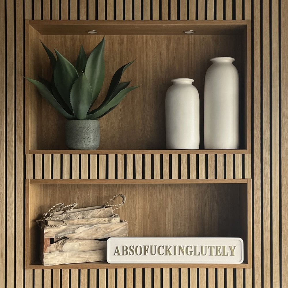 Cream 'absofuckinglutely' street sign with gold foiled text in a calming setting