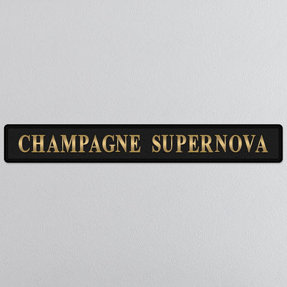 Black and gold foiled street sign with 'Champagne Supernova' wording.