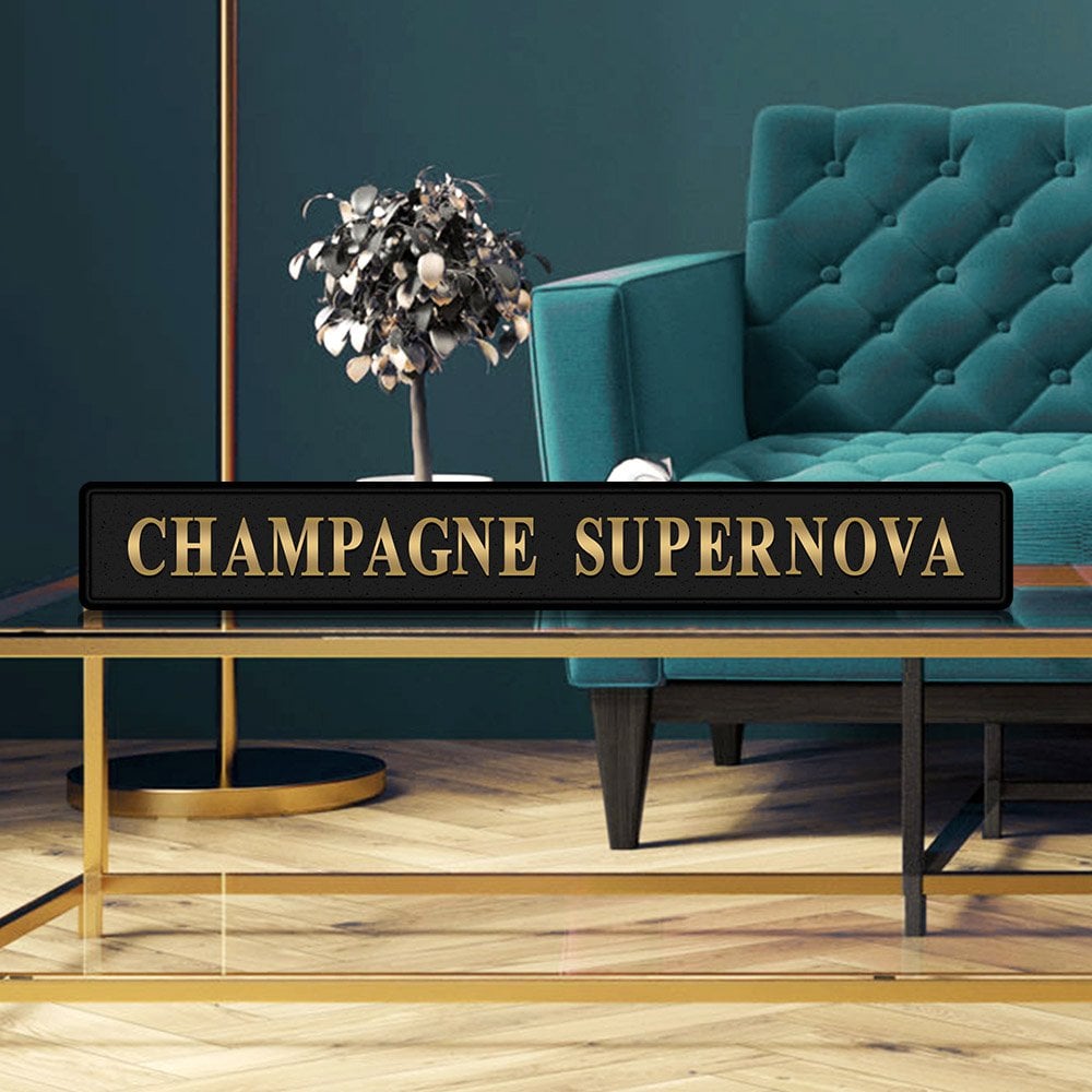 Black and gold foiled street sign with 'Champagne Supernova' wording.