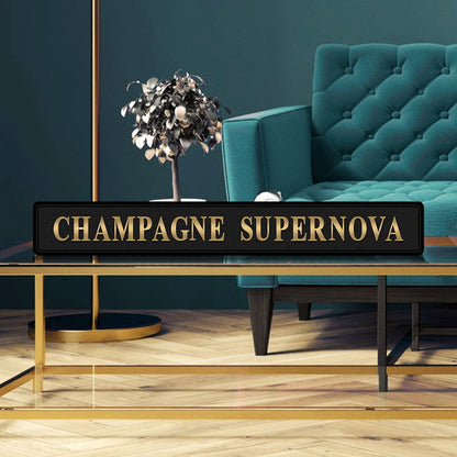 Black and gold foiled street sign with 'Champagne Supernova' wording.