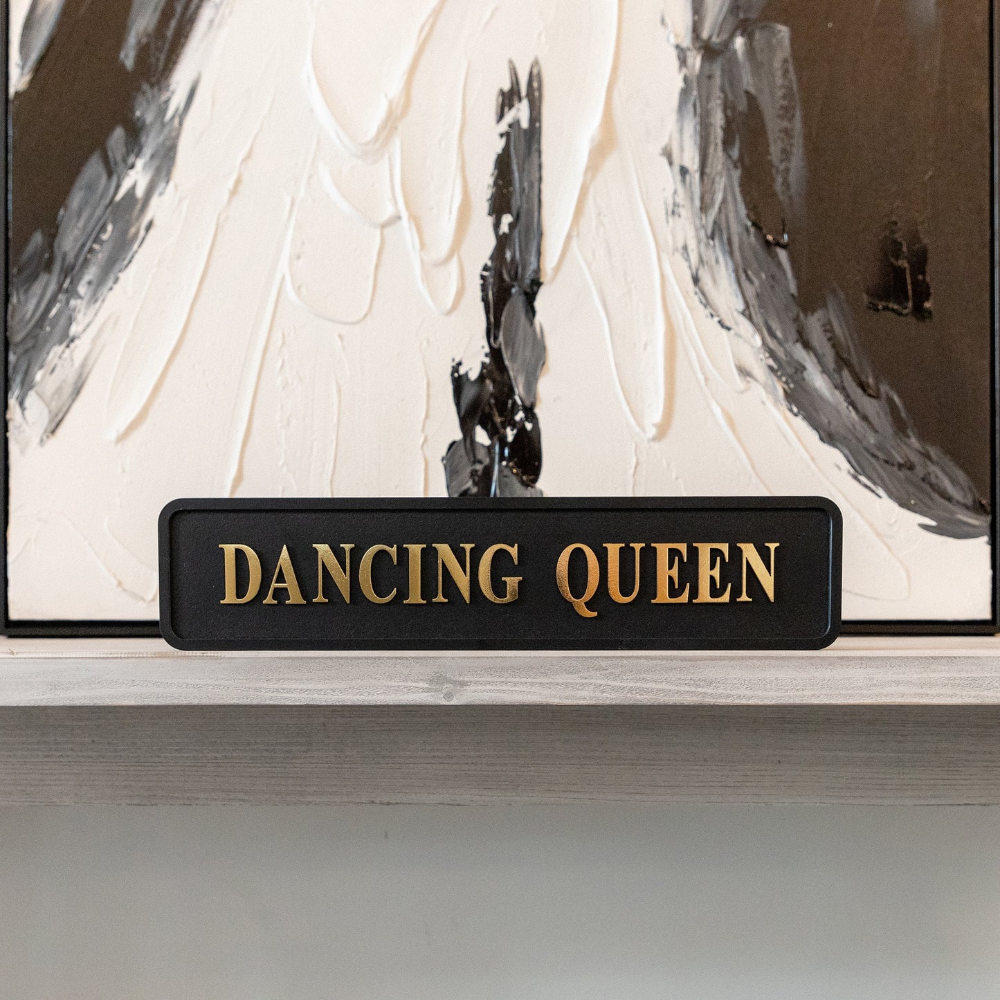 Black and gold foiled street sign with 'Dancing Queen' wording