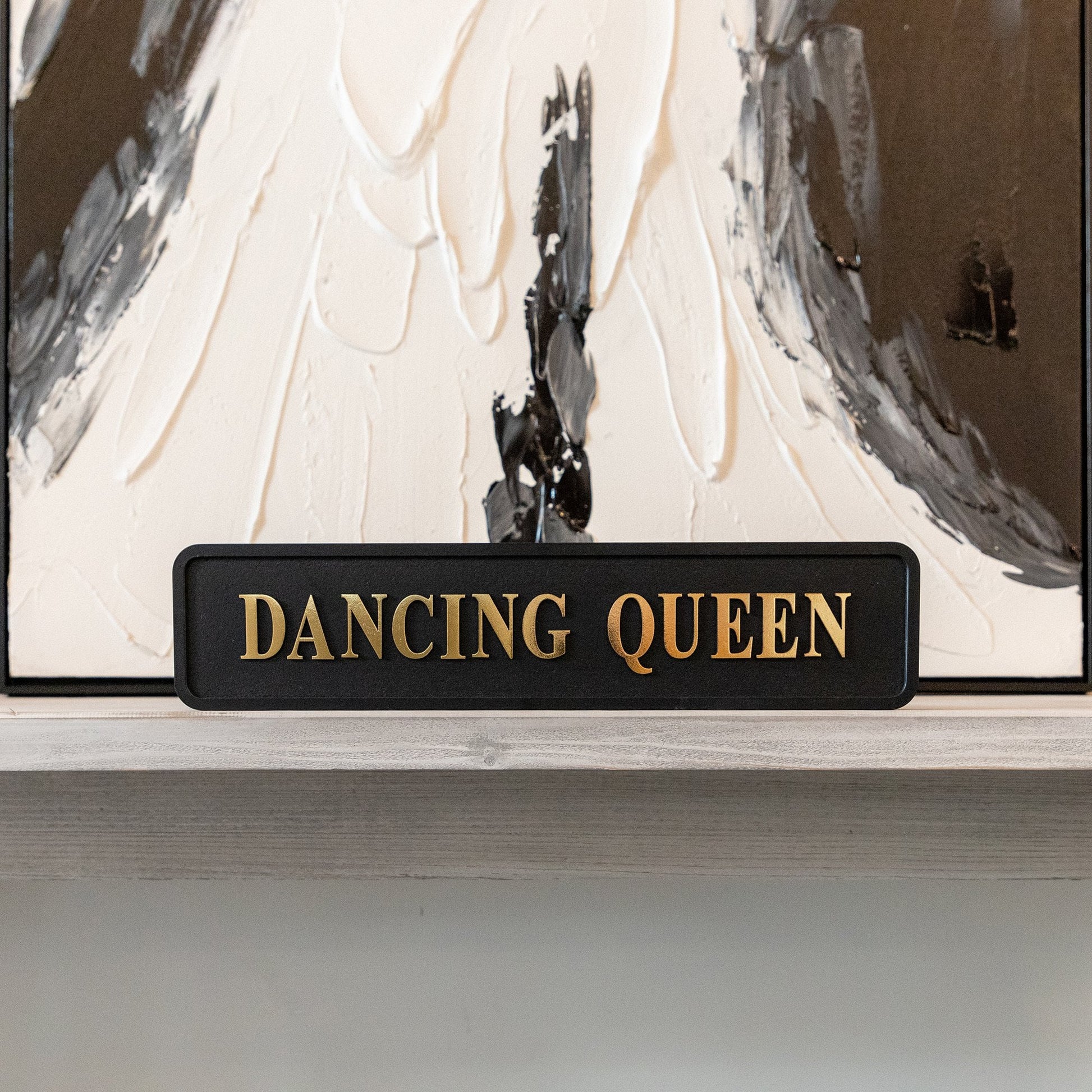 Black and gold foiled street sign with 'Dancing Queen' wording