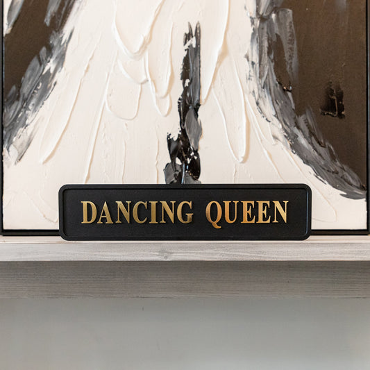 Black and gold foiled street sign with 'Dancing Queen' wording