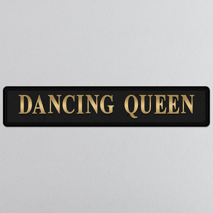 Black and gold foiled street sign with 'Dancing Queen' wording