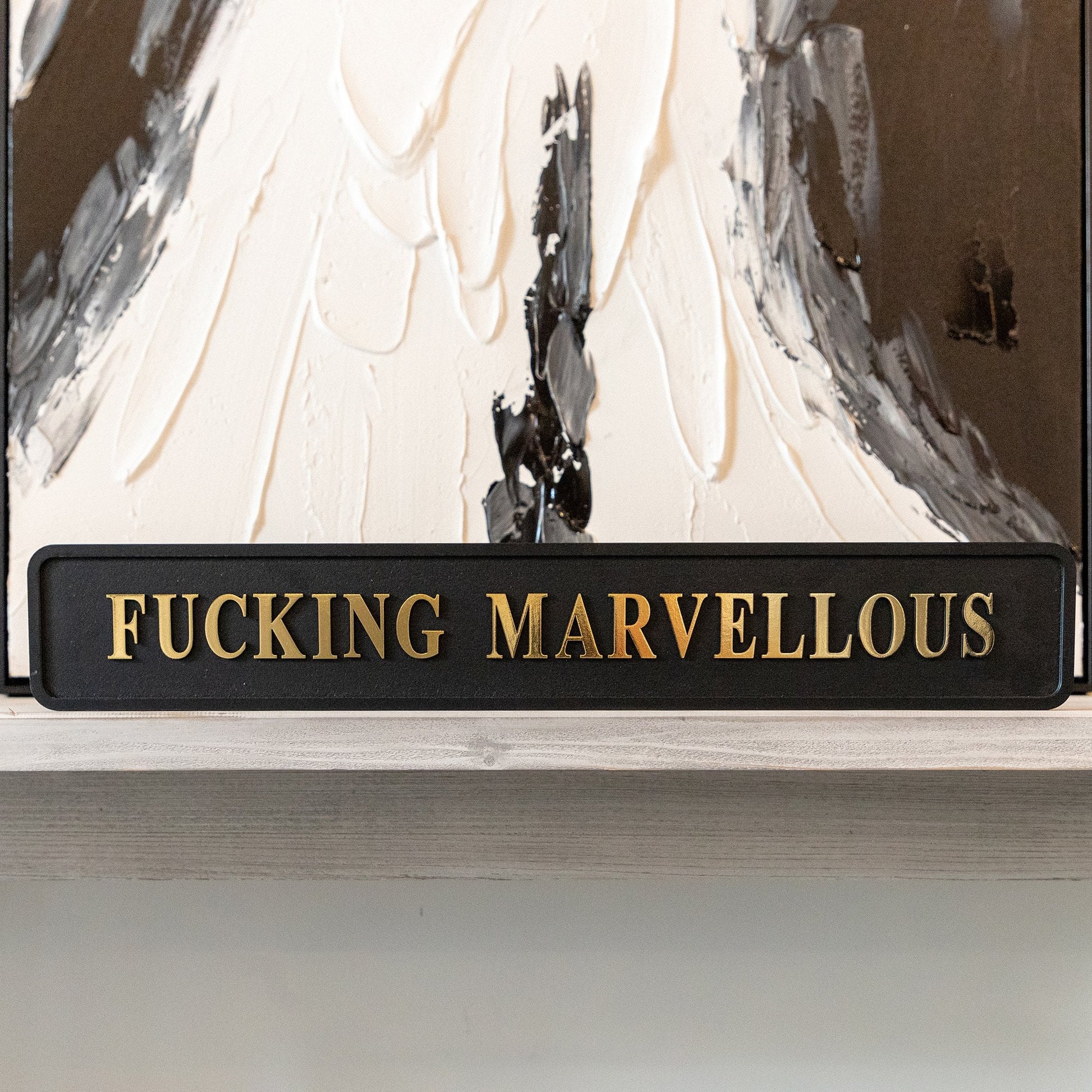 Black and gold foiled street sign with 'Fucking Marvellous' wording.