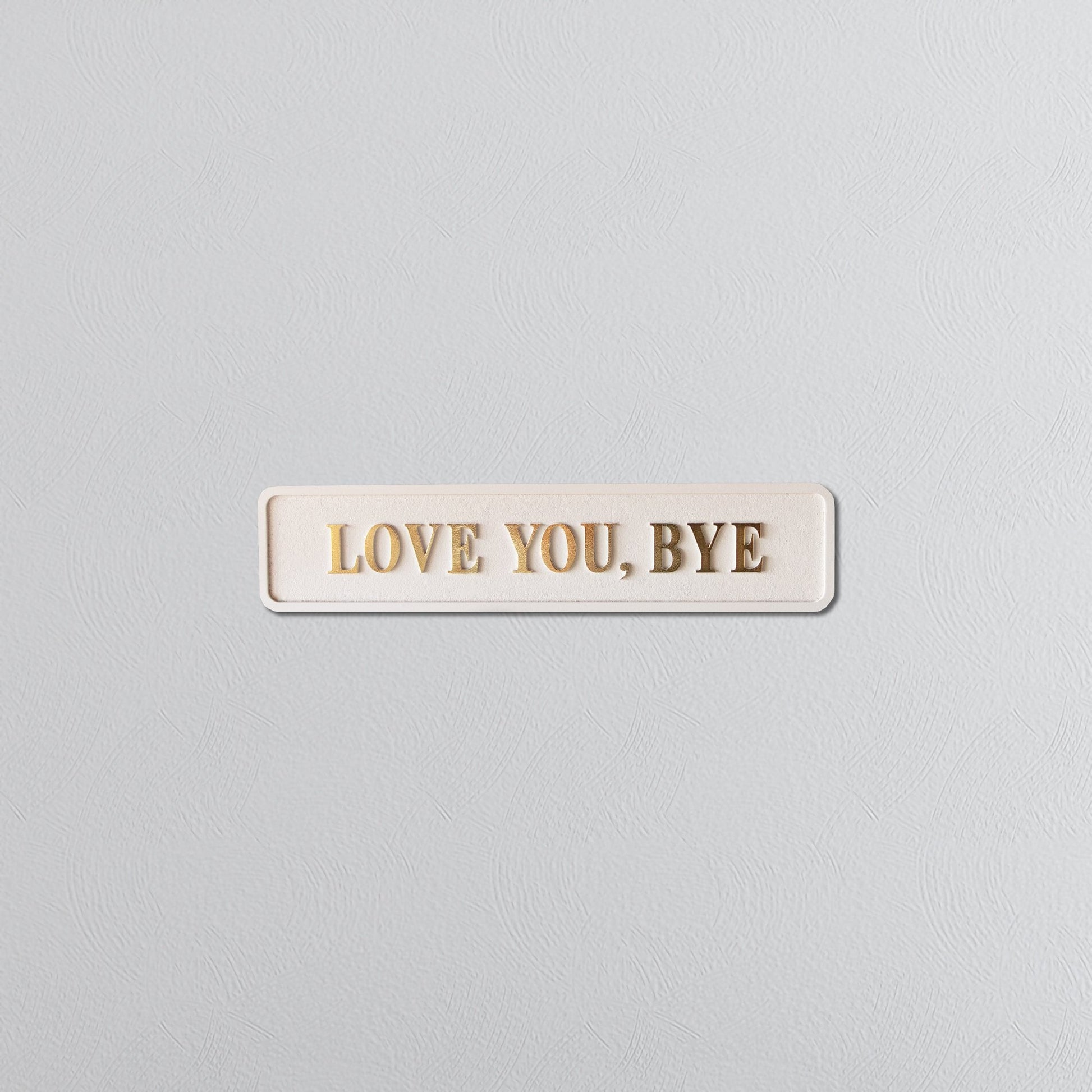 Cream and gold foiled street sign with "love you, bye" lettering