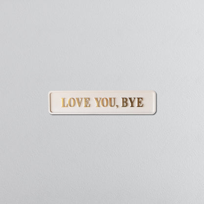 Cream and gold foiled street sign with "love you, bye" lettering
