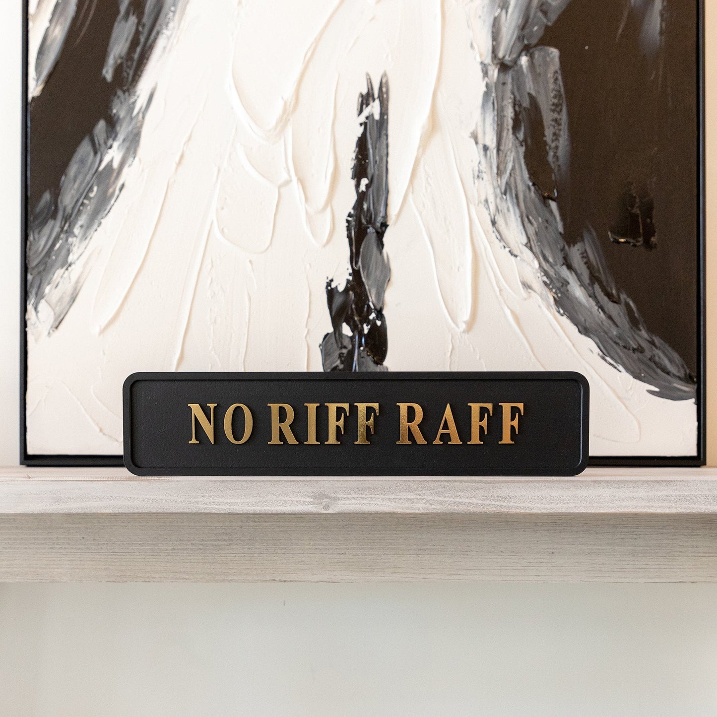 Black and gold foiled street sign with 'No Riff Raff' wording