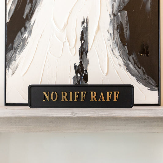 Black and gold foiled street sign with 'No Riff Raff' wording