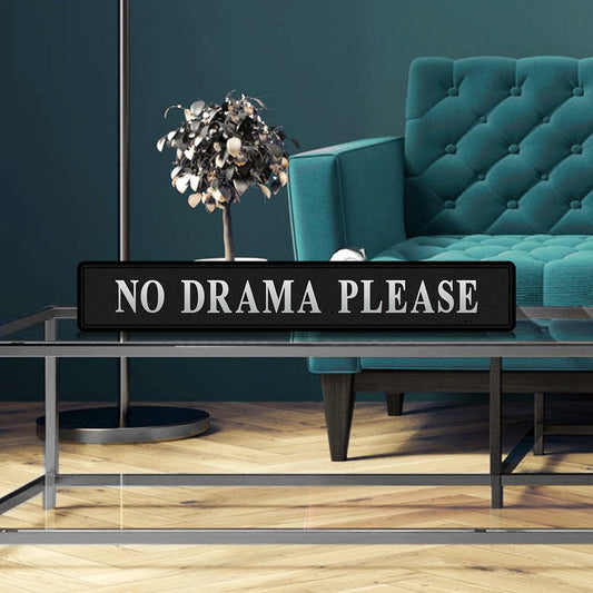 Black and silver foiled street sign with 'No drama please' wording