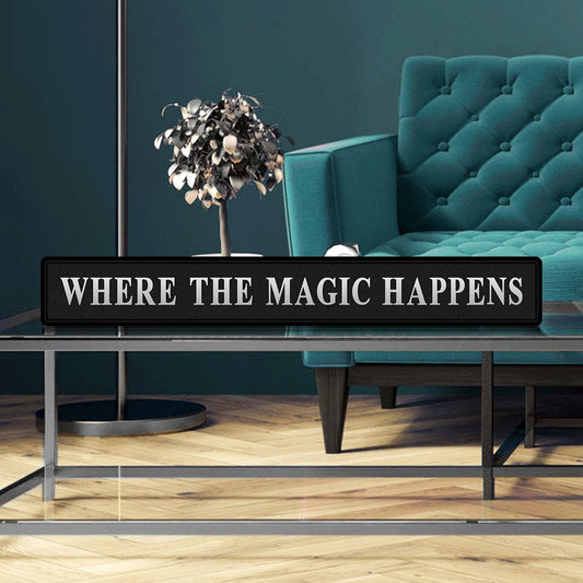 Black and silver foiled street sign with 'Where the magic happens' wording