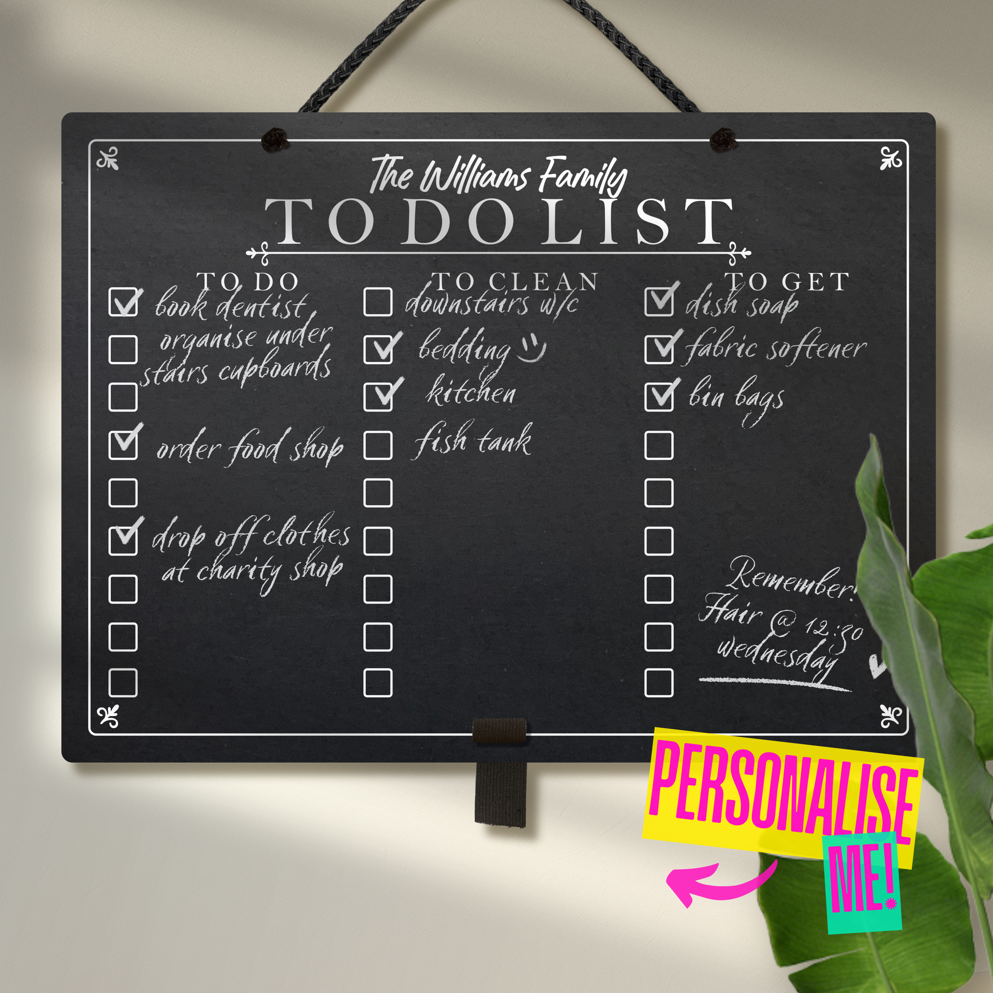 Large landscape chalkboard hanging from black rope with an adjustable elastic pen holder at the bottom. Featuring printed 'to do' 'to clean' 'to get' collumn headers with check boxes and 'The Williams Family To Do List' at the top. A colourful sign saying 'Personalise me' points towards the chalkboard.