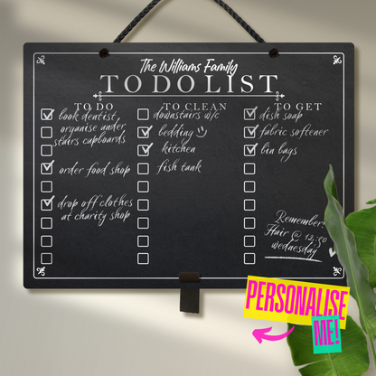 Large landscape chalkboard hanging from black rope with an adjustable elastic pen holder at the bottom. Featuring printed 'to do' 'to clean' 'to get' collumn headers with check boxes and 'The Williams Family To Do List' at the top. A colourful sign saying 'Personalise me' points towards the chalkboard.
