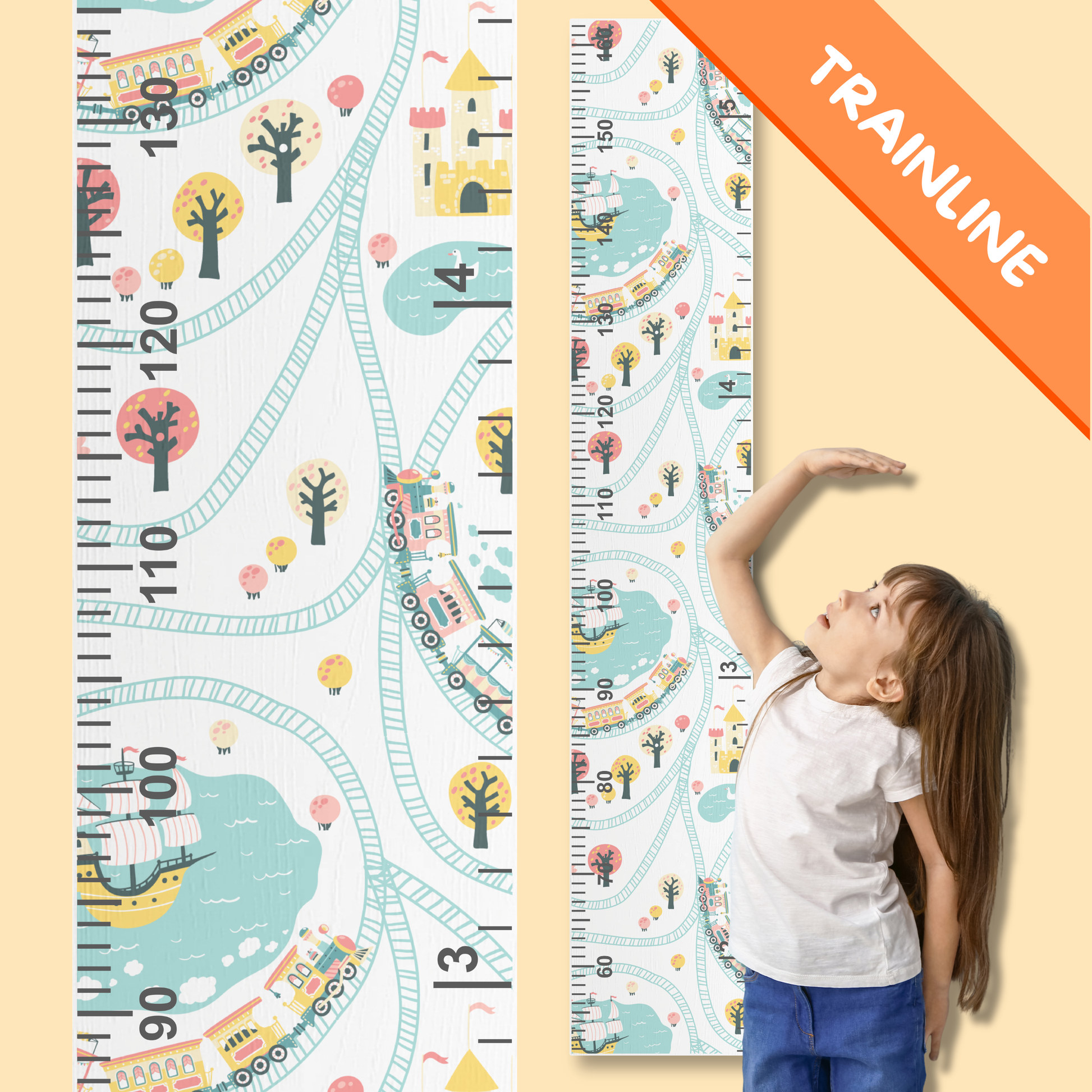 Child standing next to a growth chart with train design