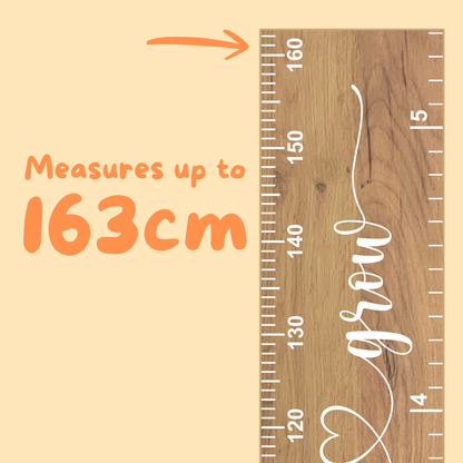 Wooden growth chart with measurement scale indicating the ruler measures up to 163 cm