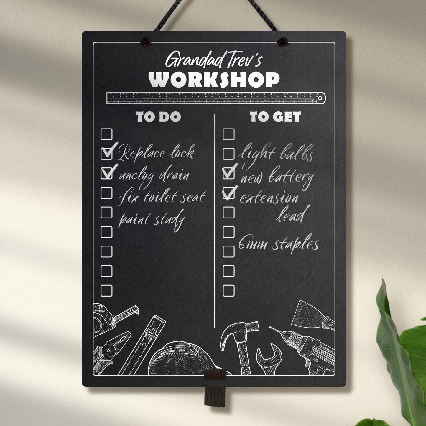 Large chalkboard hanging from a black rope with elastic pen holder at the bottom, featuring "to do" and "to get" collumn headers and check boxes printed with "Grandad Trev's Workshop" printed at the top. 