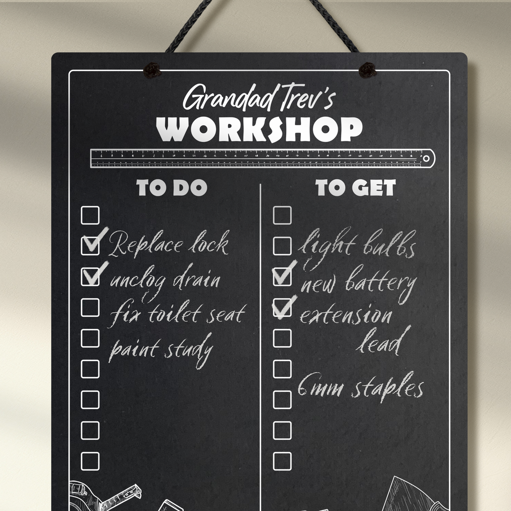 Close up of a chalkboard hanging from a black rope, featuring "to do" and "to get" collumn headers and check boxes printed with "Grandad Trev's Workshop" printed at the top. Example chalk notes listing items to be done and bought added.